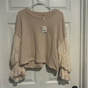 Free People. New with tags.  Long sleeve women's top. Size Lg